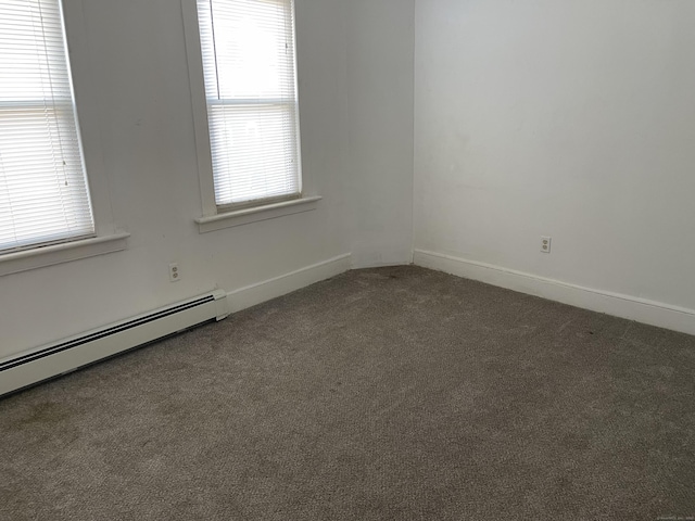 carpeted spare room with baseboard heating