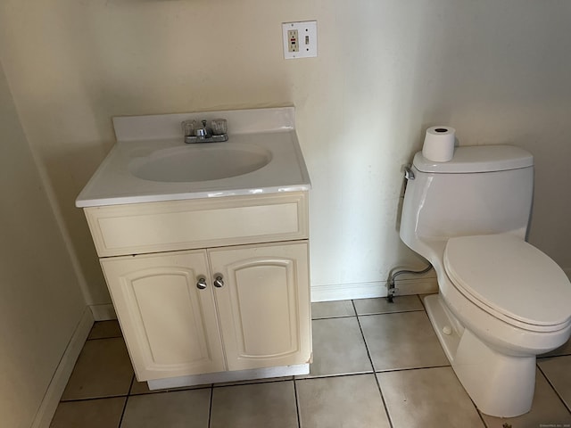 bathroom featuring tile patterned floors, vanity, and toilet