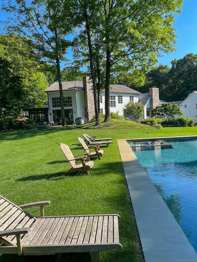 rear view of house featuring a lawn