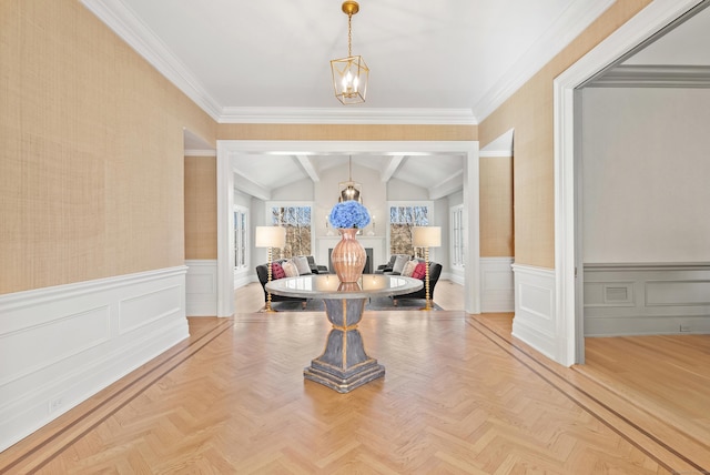 dining area featuring ornamental molding, lofted ceiling with beams, and light parquet flooring