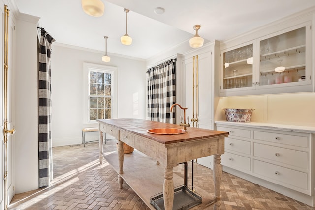 home office featuring ornamental molding and sink