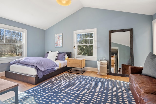 bedroom with lofted ceiling and hardwood / wood-style flooring