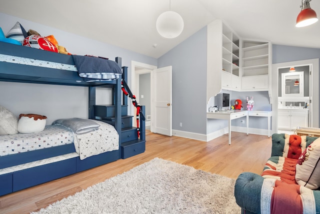 bedroom with light hardwood / wood-style flooring and vaulted ceiling