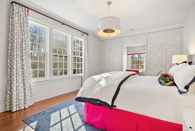 bedroom with dark hardwood / wood-style flooring