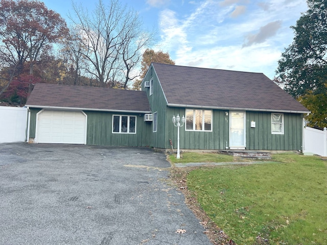 view of front of house featuring a front yard and a garage