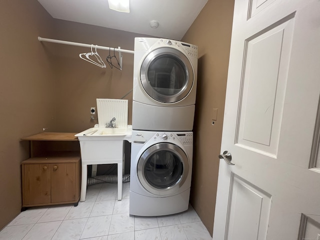 laundry room featuring stacked washer and clothes dryer