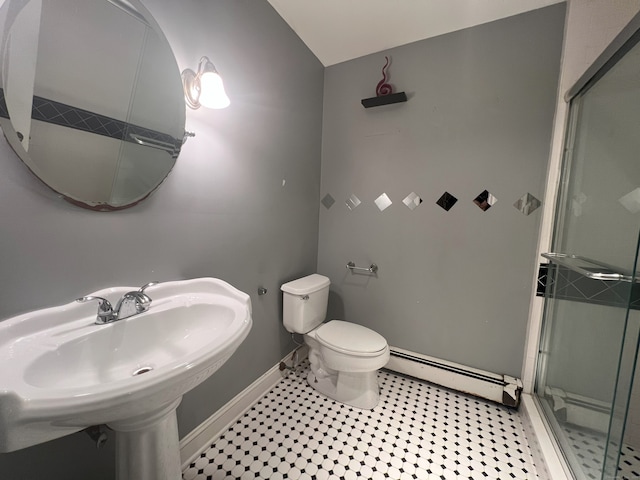 bathroom with toilet, baseboard heating, a shower with shower door, and sink