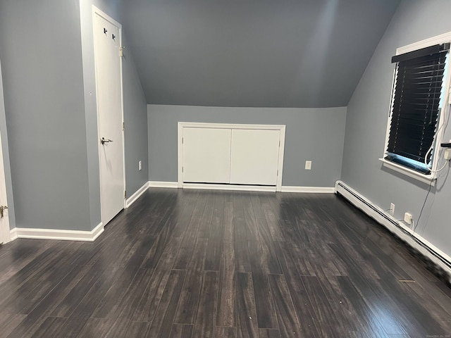 bonus room with baseboard heating, dark hardwood / wood-style flooring, and lofted ceiling