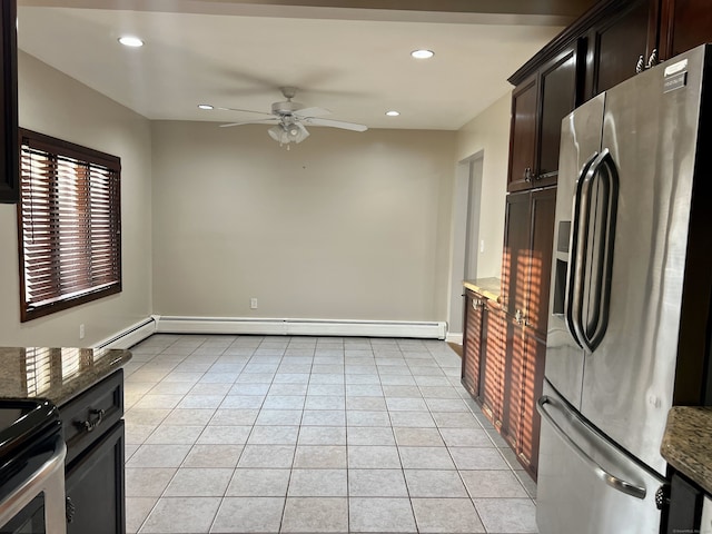 kitchen featuring ceiling fan, a baseboard heating unit, light tile patterned floors, dark stone countertops, and stainless steel fridge with ice dispenser