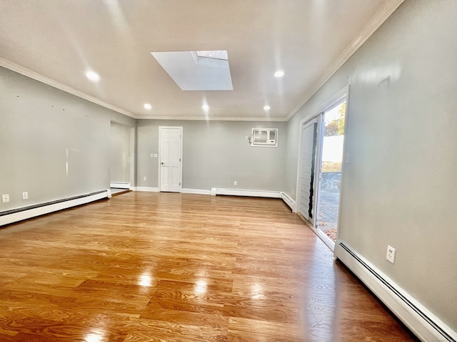 unfurnished room featuring a skylight, crown molding, a baseboard radiator, and wood-type flooring