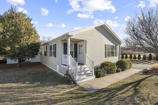 view of front of property with a front lawn, an outdoor structure, and a garage