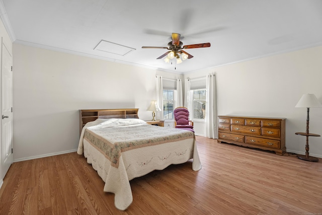 bedroom featuring light wood-type flooring, ceiling fan, and ornamental molding