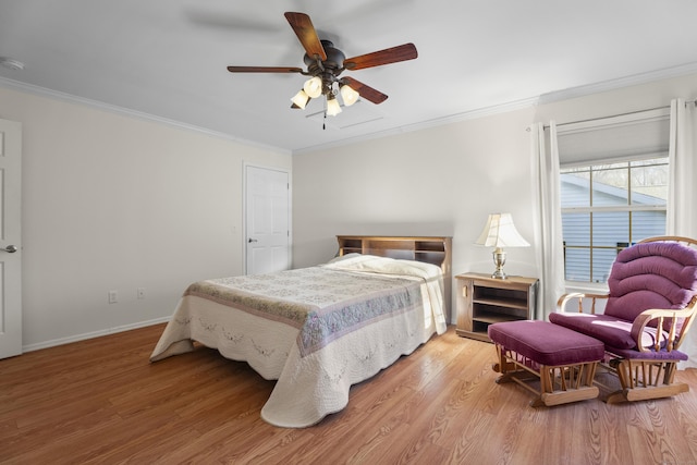 bedroom featuring wood-type flooring, ceiling fan, and ornamental molding