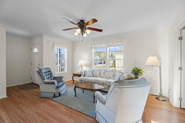 living room with ceiling fan, hardwood / wood-style floors, and ornamental molding