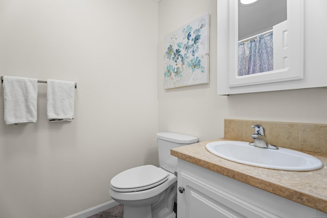 bathroom featuring tile patterned floors, vanity, and toilet