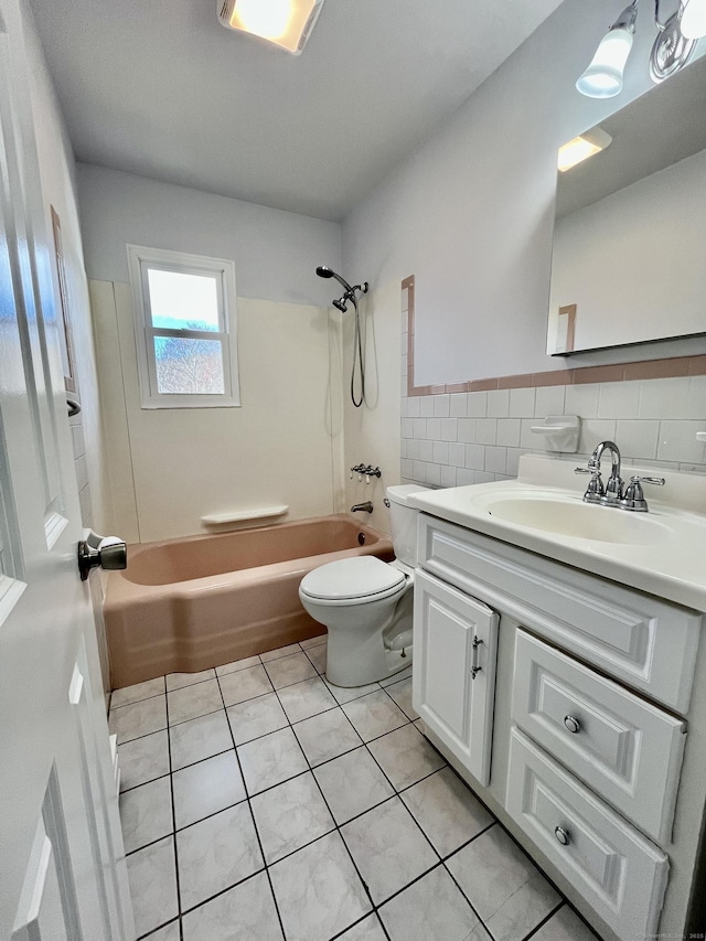 full bathroom featuring vanity, bathtub / shower combination, tile patterned flooring, toilet, and tile walls