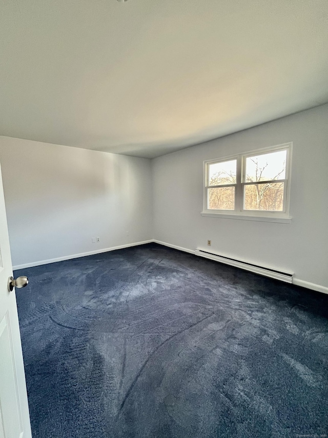 carpeted empty room with a baseboard radiator