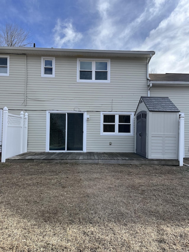 back of house featuring a shed