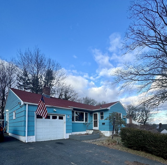 ranch-style house featuring a garage