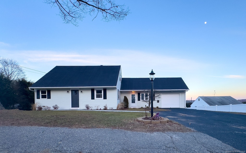 single story home with a lawn and a garage