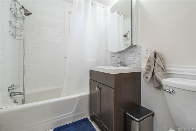 full bathroom featuring shower / bath combo, vanity, and toilet