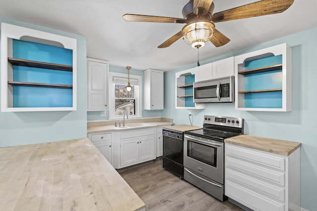 kitchen with white cabinetry, ceiling fan, stainless steel appliances, light wood-type flooring, and sink