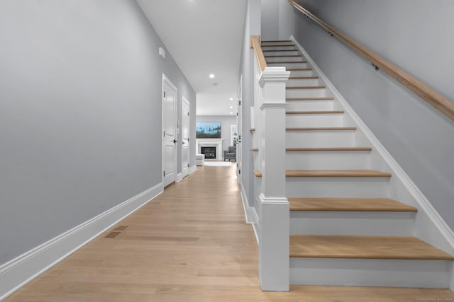 stairs with hardwood / wood-style flooring