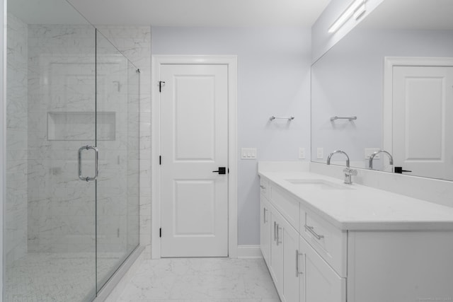 bathroom featuring vanity and a shower with door