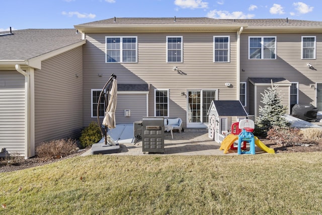 rear view of house featuring a yard and a patio