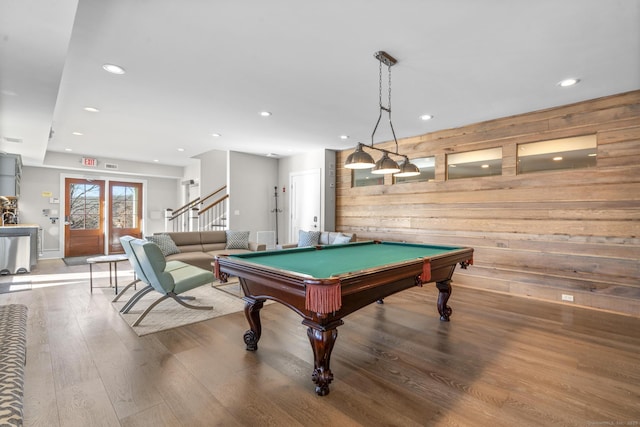 rec room with hardwood / wood-style floors, wood walls, and billiards