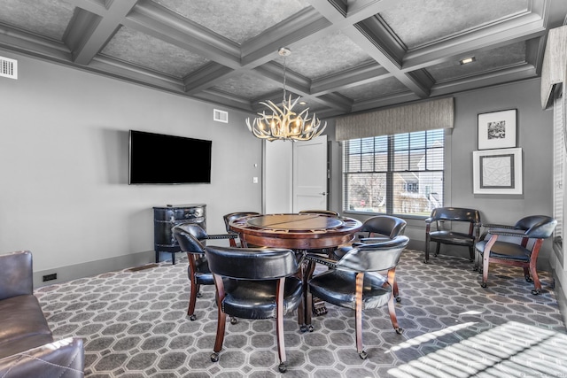 carpeted dining area featuring beamed ceiling, ornamental molding, an inviting chandelier, and coffered ceiling