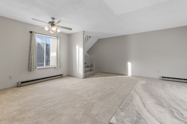 additional living space featuring ceiling fan, a baseboard radiator, a textured ceiling, and light carpet