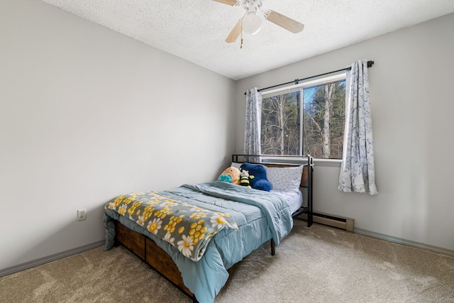 bedroom featuring ceiling fan, baseboard heating, a textured ceiling, and carpet flooring