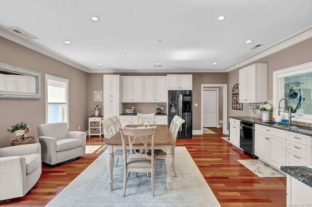 dining area with crown molding, recessed lighting, light wood-style floors, and visible vents