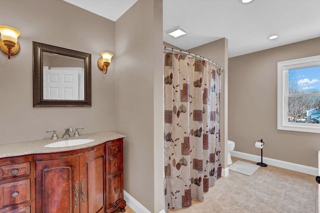 full bathroom featuring tile patterned floors, a shower with curtain, toilet, baseboards, and vanity