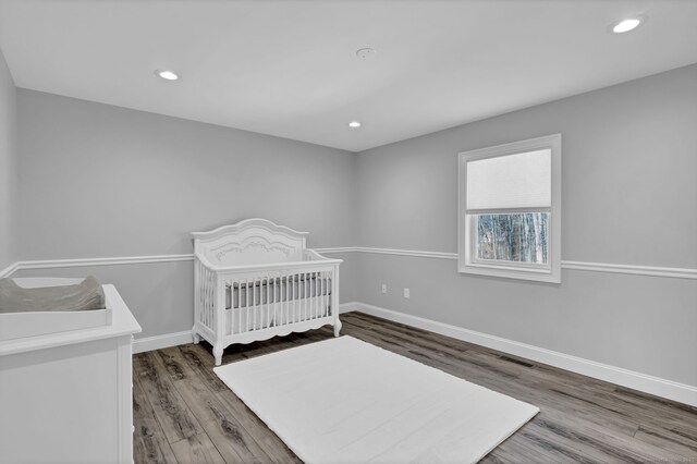 bedroom with visible vents, recessed lighting, wood finished floors, and baseboards