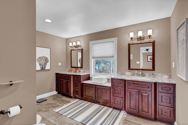 full bath with vanity and baseboards