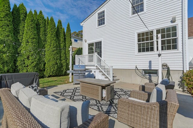 view of patio with area for grilling and an outdoor living space