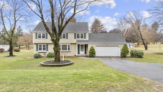 view of front of property with a garage and a front lawn