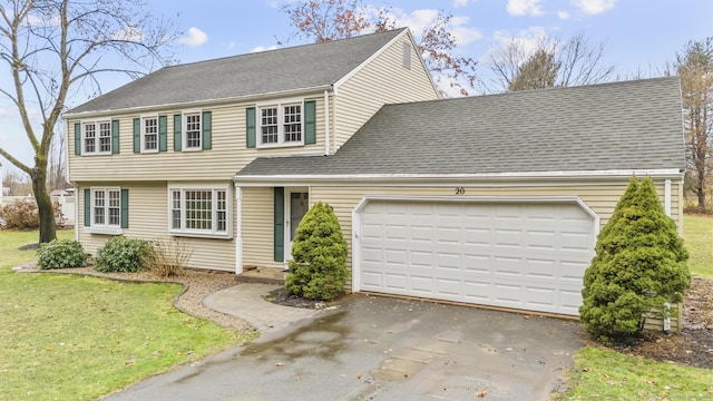 view of front facade with a front yard and a garage