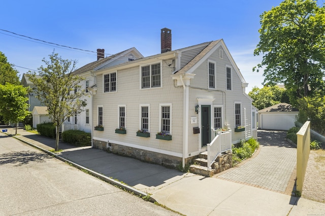 view of front facade with an outdoor structure and a garage