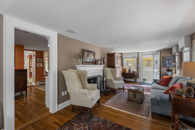 living room featuring a baseboard radiator and hardwood / wood-style flooring