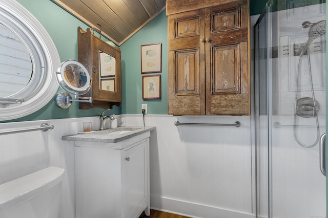 bathroom featuring vaulted ceiling, toilet, a shower with door, vanity, and wood ceiling