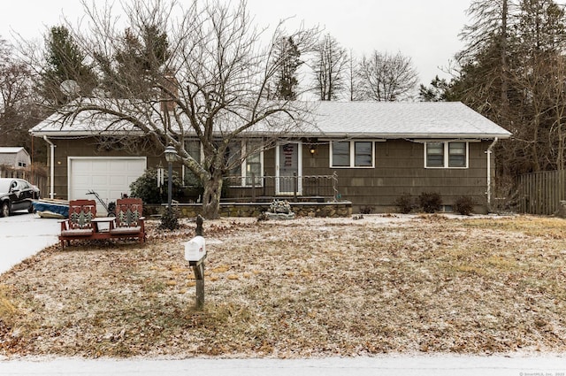 single story home featuring covered porch and a garage