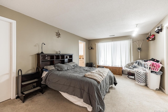 carpeted bedroom featuring a textured ceiling