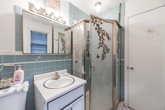 bathroom with toilet, a shower with door, and tile walls