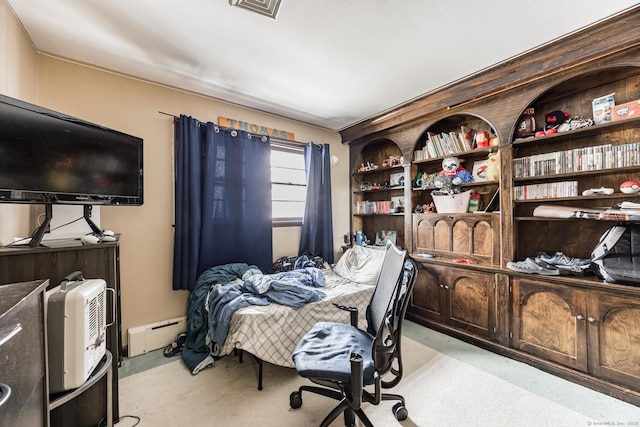 carpeted bedroom featuring a baseboard heating unit