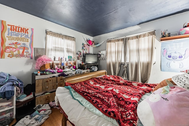 bedroom with hardwood / wood-style flooring