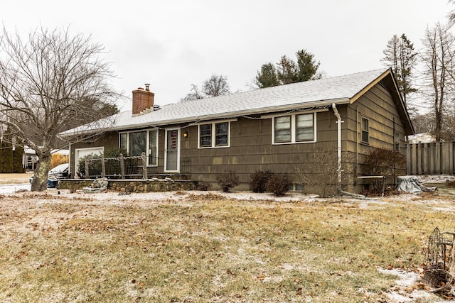 ranch-style home with a garage and a front yard