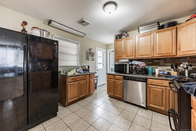 kitchen featuring decorative backsplash, light tile patterned floors, and black appliances